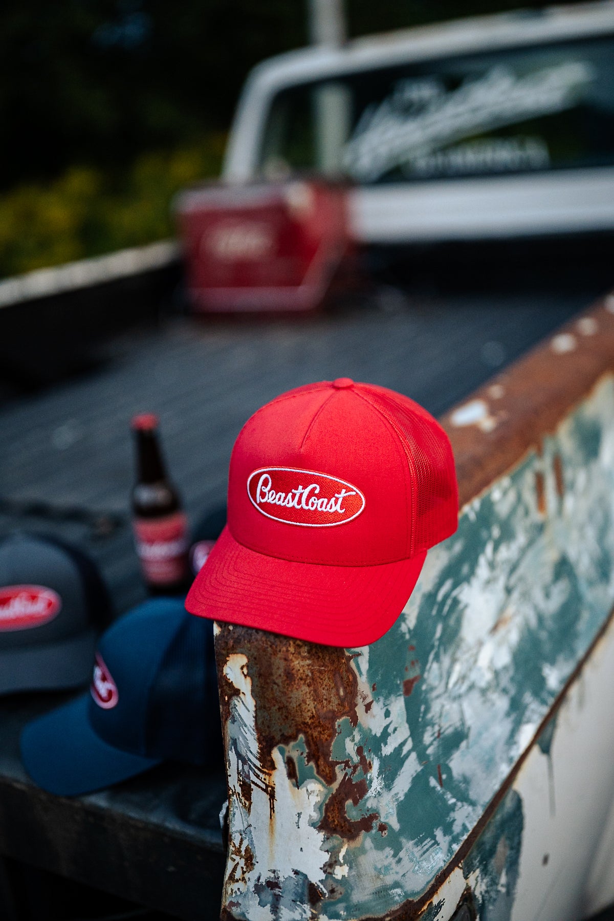 BeastCoast Americana Trucker hat in red on a pickup truck bed