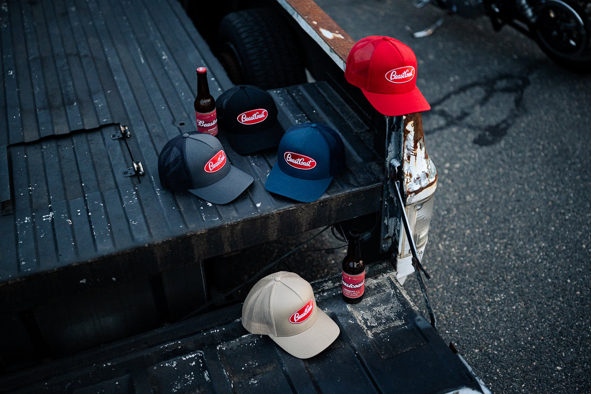 BeastCoast Americana Trucker hats in all colors on a tailgate