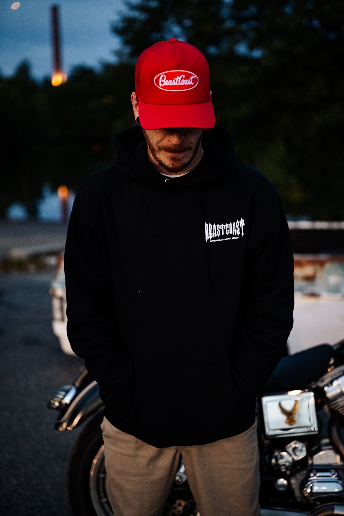BeastCoast Americana Hoodie in black, front view by a motorcycle