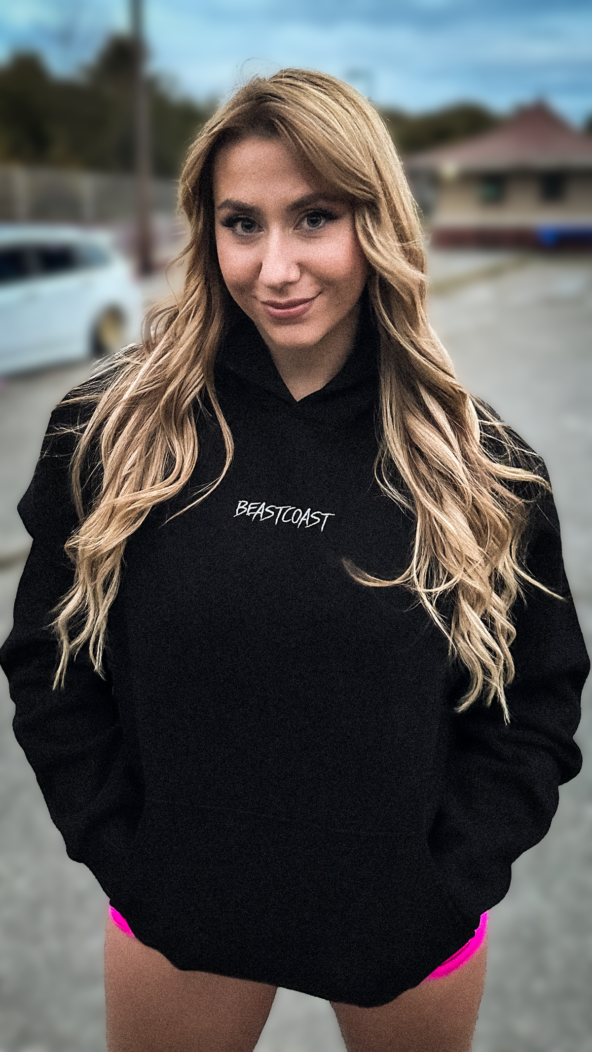 BeastCoast Minimalist Hoodie in black with small chest embroidery, front view on model